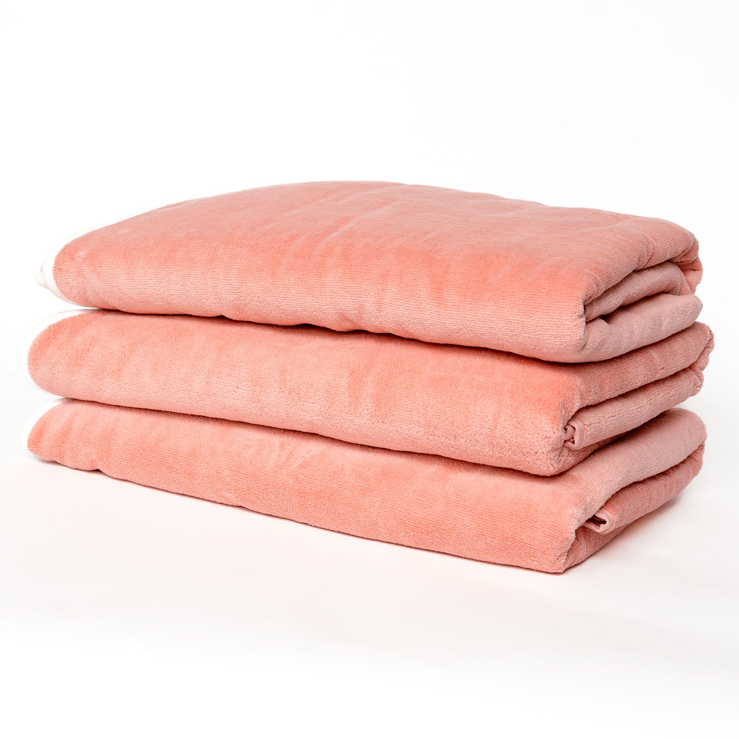 3 coral colored towels neatly stacked