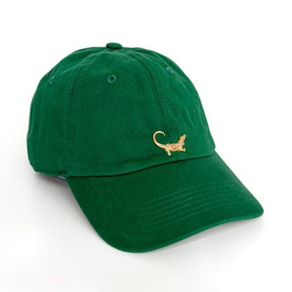 A green baseball hat with a gold alligator emblem on the front.